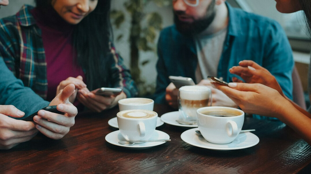 diverse group talking about phones