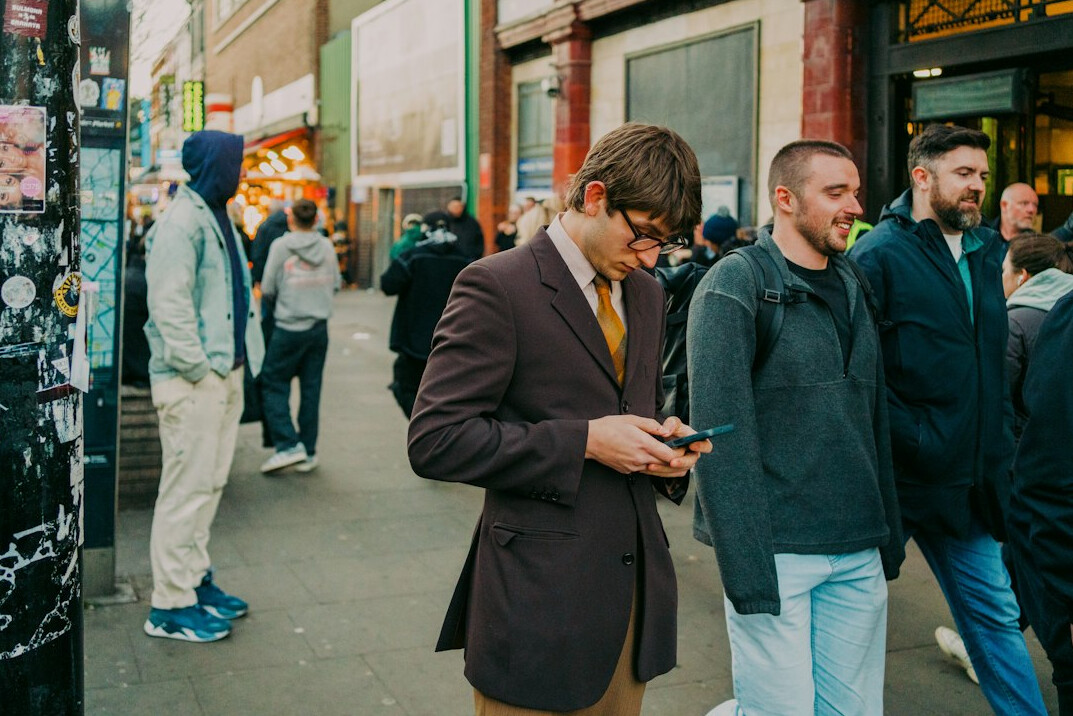 people using smartphones in public
