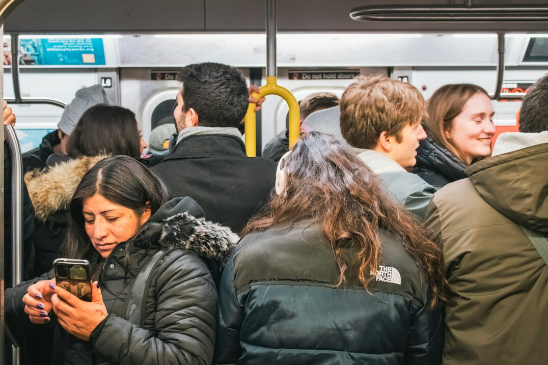 people using smartphones in public