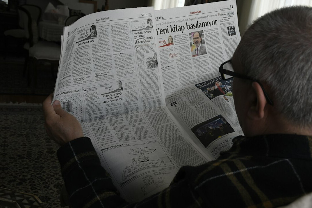 person reading newspaper