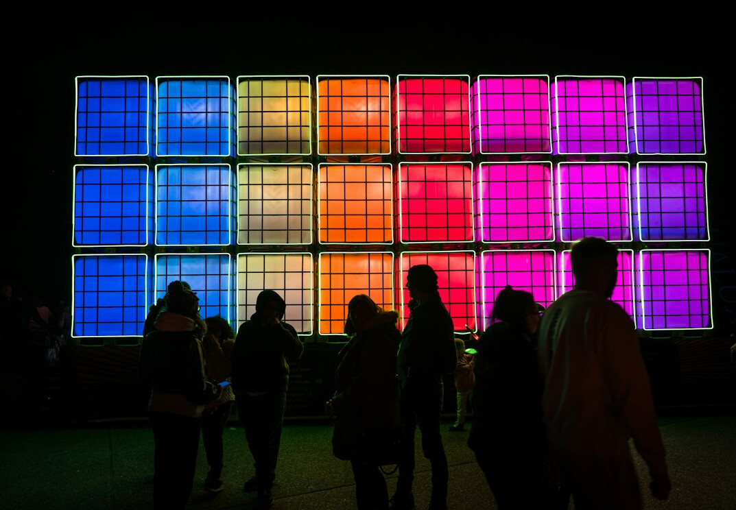 Large screen displaying colourful data visualization charts